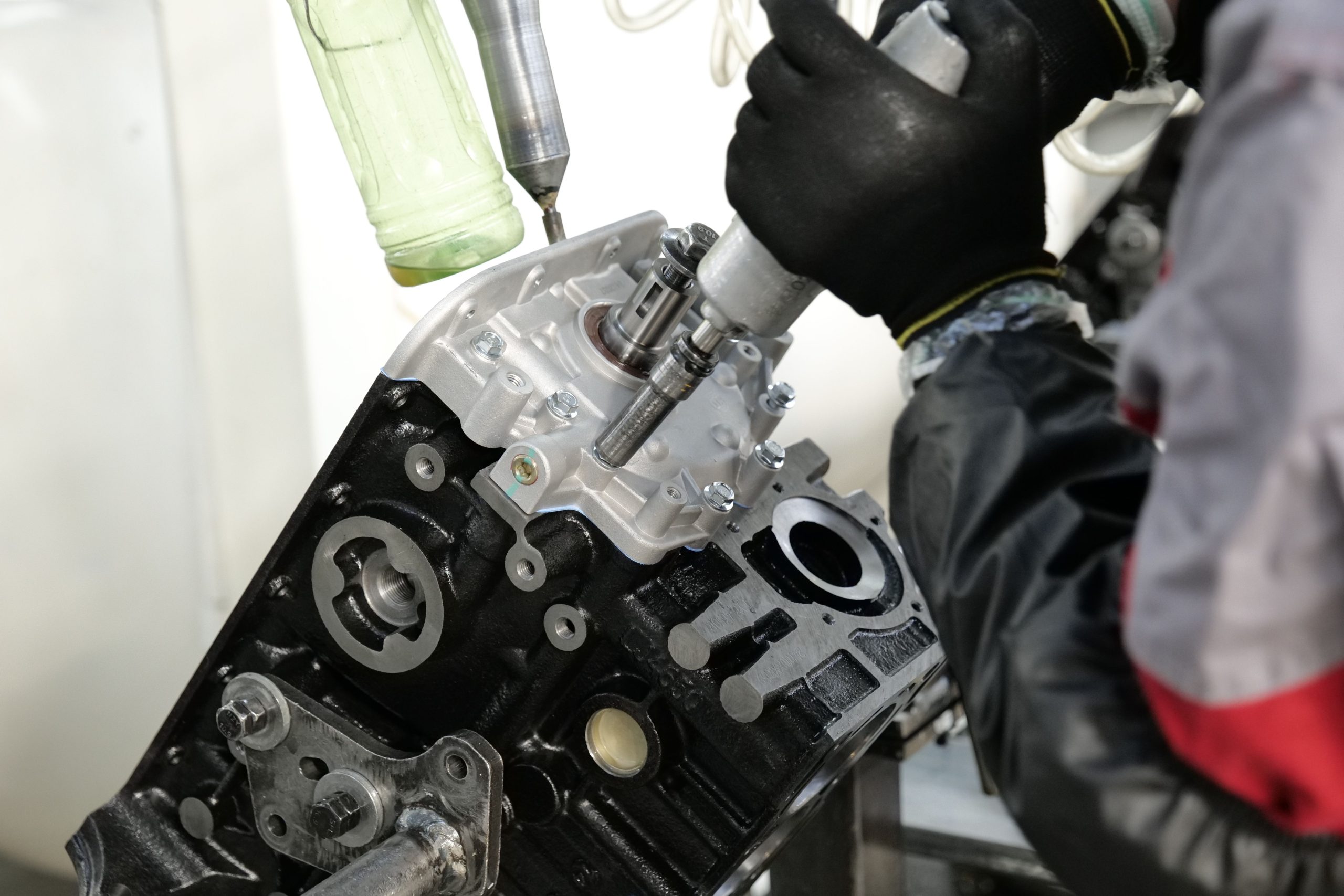 Technician assembling an engine block on a production line